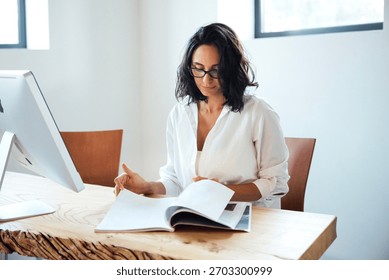 Professional engaged in reading business insights